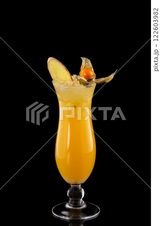 Closeup glass of fresh orange juice with ice decorated with ginger isolated at black background. 122603982