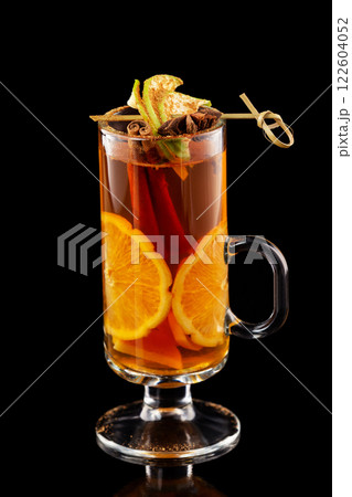 Closeup cup of tea with orange and cinnamon isolated at black background. 122604052