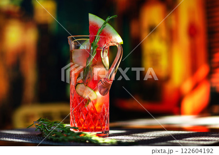 Closeup jug of watermelon sangria at colorful bar background. Closeup jug of watermelon sangria at colorful bar background. 122604192