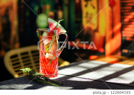Closeup jug of watermelon sangria at colorful bar background. 122604193