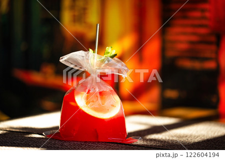Red strawberry lemonade served in a plastic bag at bar background. Red strawberry lemonade served in a plastic bag at bar background. 122604194