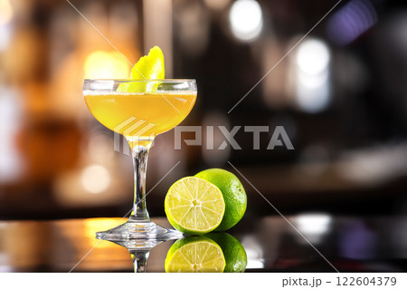 Closeup image of daiquiri cocktail decorated with lemon at bar counter background. Closeup image of daiquiri cocktail decorated with lemon at bar counter background. 122604379