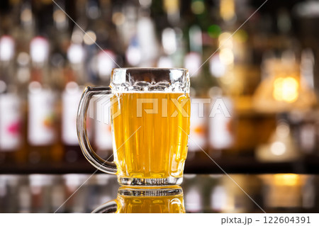 Closeup image of mug with golden cold light beer at bar background. 122604391