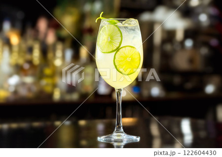 Glass of lime lemonade at bar counter background. Glass of lime lemonade at bar counter background. 122604430