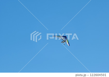 White Hang Glider against blue sky 122604501