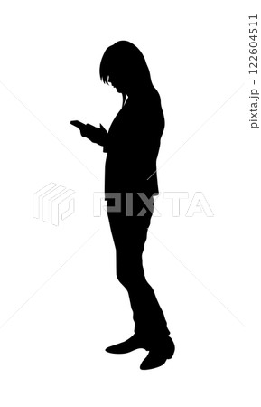 The silhouette of a woman standing using her phone emphasizes the connection women have with technology The silhouette of a woman standing using her phone emphasizes the connection women have with technology 122604511