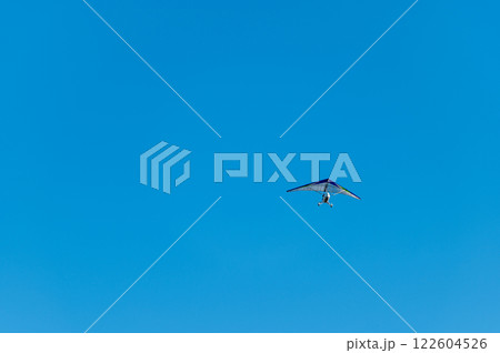 White Hang Glider against blue sky 122604526