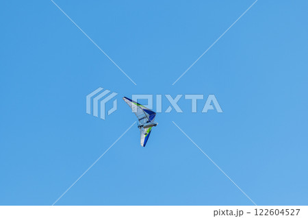 White Hang Glider against blue sky 122604527