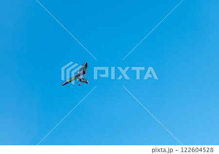 White Hang Glider against blue sky 122604528