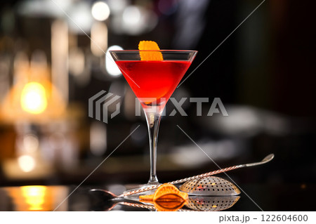 Closeup glass of Manhattan cocktail decorated with orange at bar counter background. Closeup glass of Manhattan cocktail decorated with orange at bar counter background. 122604600