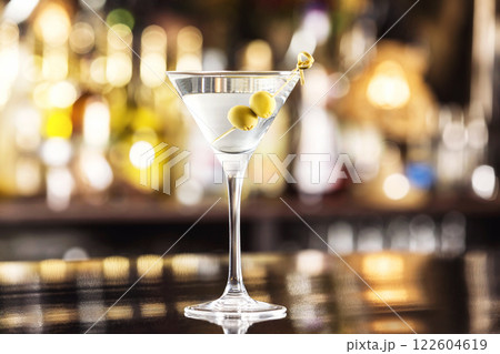 Closeup glass of martini dry cocktail with olives at bar counter background. 122604619