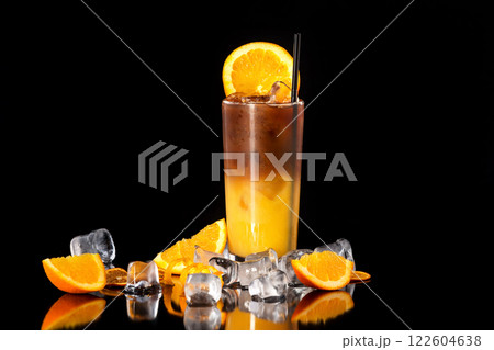 Closeup glass of fresh orange juice mixed with coffee isolated at black background. 122604638
