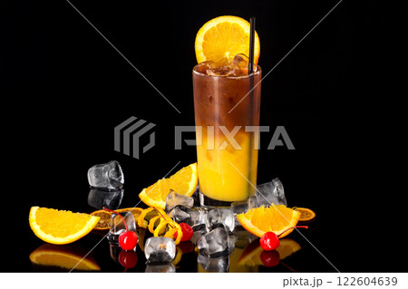 Closeup glass of fresh orange juice mixed with coffee isolated at black background. 122604639