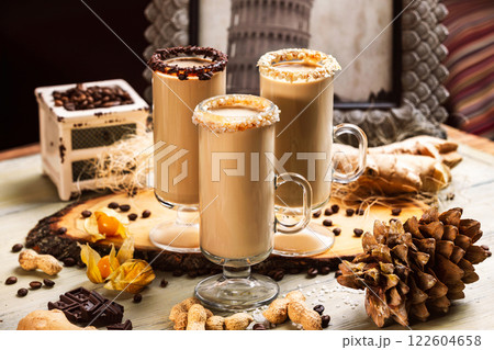 Closeup group of hot coffee glasses decorated with beans, nuts and fruits at wooden table background. 122604658