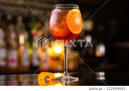 Closeup glass of spritz aperol cocktail decorated with orange at bright bar counter background. 122604681