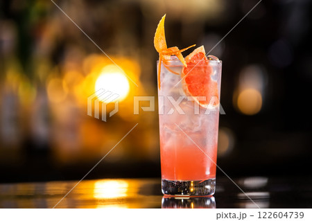 Closeup glass of greyhound cocktail decorated with grapefruit at bright bar counter background. 122604739