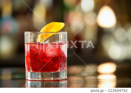 Closeup glass of red negroni cocktail at bar counter background. 122604782