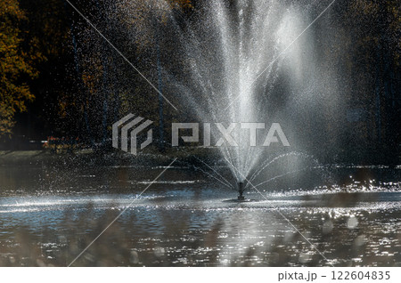 Water fountain in the park illuminated by the evening sun in Vecpiebalga, Latvia Water fountain in the park illuminated by the evening sun in Vecpiebalga, Latvia 122604835