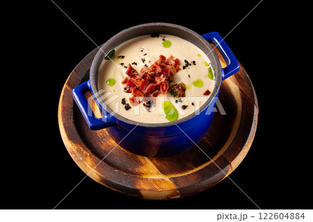 Cream soup with cauliflower and bacon at wooden tray isolated at black background. Cream soup with cauliflower and bacon at wooden tray isolated at black background. 122604884