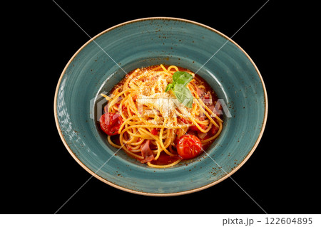Arabyata pasta with bacon, tomato sauce and parmesan isolated at black background. Arabyata pasta with bacon, tomato sauce and parmesan isolated at black background. 122604895