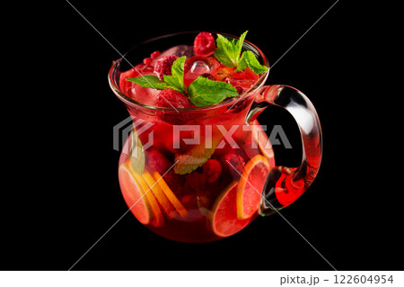 Glass jar of red wine sangria with wild berries and citrus mix isolated at black background. 122604954