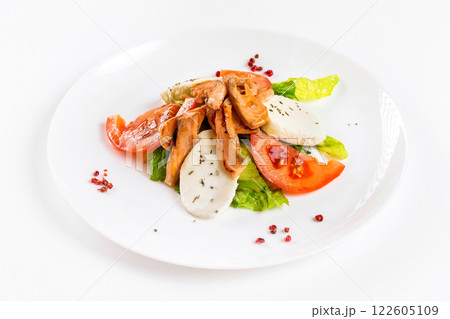 Plate of grilled salmon fish with cheese and vegetables isolated at white background. Plate of grilled salmon fish with cheese and vegetables isolated at white background. 122605109