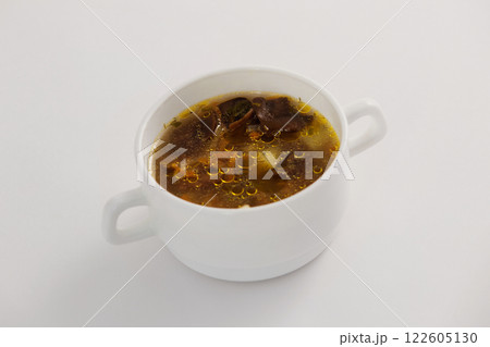 Closeup image of mushroom soup bowl isolated at white background. Closeup image of mushroom soup bowl isolated at white background. 122605130