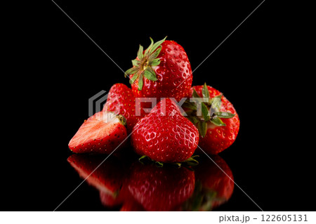 Macro image of fresh red strawberries group isolated at black background with reflection. Macro image of fresh red strawberries group isolated at black background with reflection. 122605131