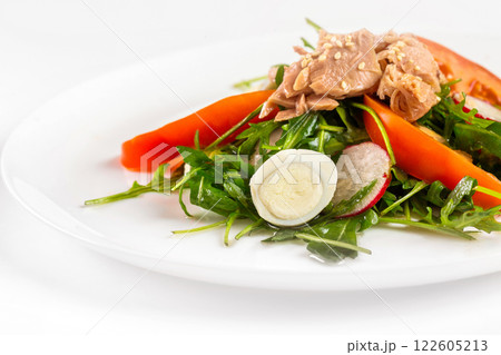 Plate of tuna salad with fresh vegetables isolated at white background. Plate of tuna salad with fresh vegetables isolated at white background. 122605213