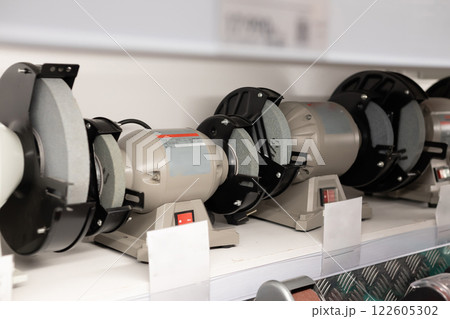 Various grinding machines displayed on a shelf in a tool store during daylight hours 122605302