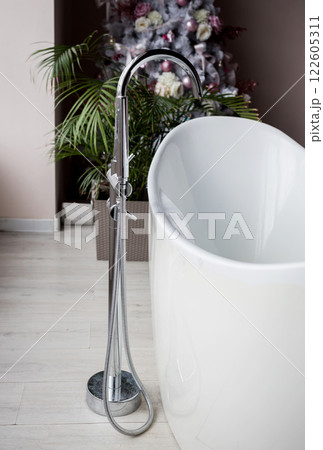 bathtub with stainless steel faucet 122605311