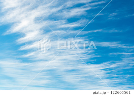 Cirrus vertebratus is a type of cirrus cloud. Blue sky background. Cirrus vertebratus is a type of cirrus cloud. Blue sky background. 122605561