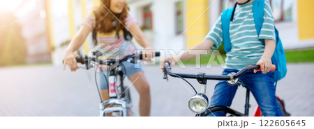 Boy and girl on the bicycles riding together. 122605645
