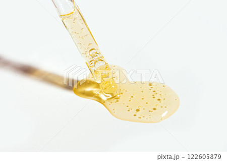 Dropper with  swatch of cosmetic retinol serum 122605879