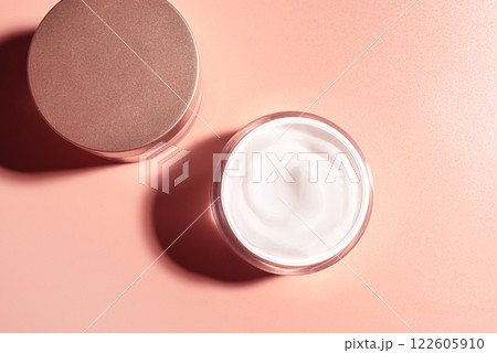 Cosmetic cream jar on pink beige background Cosmetic cream jar on pink beige background 122605910