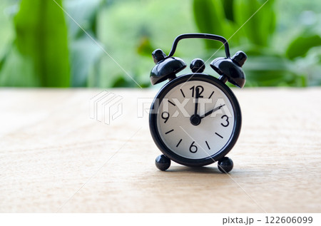 Table alarm clock pointing at 2pm or 2am with customizable space for text. Time management concept and copy space 122606099