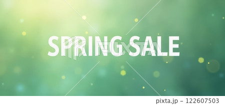 Spring sale text on green blurred background with bokeh light effects. Minimalistic banner design with copy space 122607503