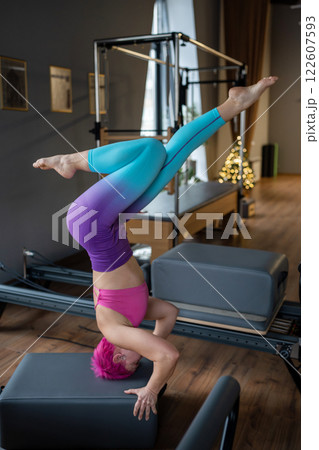 A Dynamic Yoga Pose Demonstrated in a Contemporary Modern Studio Setting Filled with Energy 122607593