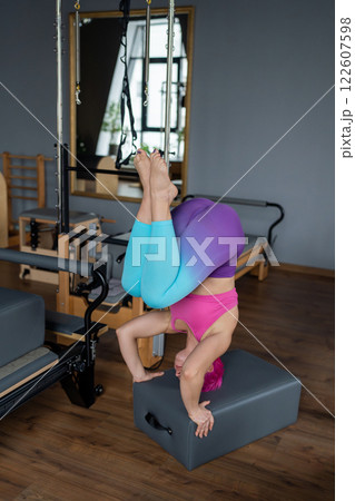 The Yoga Headstand Pose, complemented by vibrant and colorful leggings, truly shines 122607598