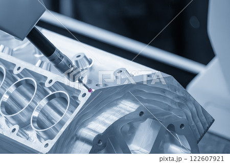 The multi axis CMM machine measuring the aluminum cylinder block parts in the light blue scene. The multi axis CMM machine measuring the aluminum cylinder block parts in the light blue scene. 122607921