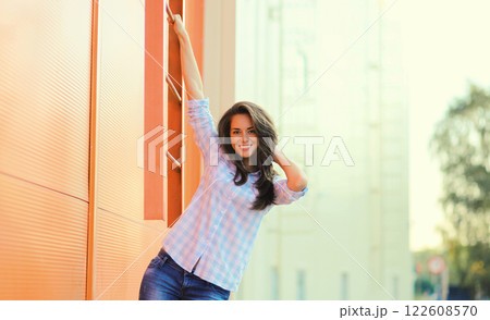 Portrait beautiful happy smiling brunette young woman posing in the city Portrait beautiful happy smiling brunette young woman posing in the city 122608570