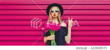 Beautiful stylish woman with bouquet of pink rose flowers blowing kiss on colorful background Beautiful stylish woman with bouquet of pink rose flowers blowing kiss on colorful background 122608571
