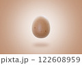 Single speckled brown egg floating against soft beige gradient background, creating minimalistic and conceptual composition with copy space 122608959