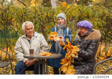 Happy grandparents and grandkid enjoying in autumn park Happy grandparents and grandkid enjoying in autumn park 122609294