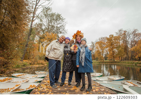 Portrait of happy family generation together in autumn park 122609303