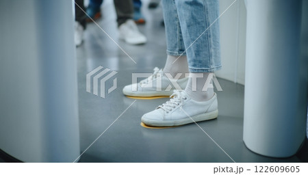 Knee Level Shot of Unrecognizable Passengers Walking Through X-ray Metal Detector Scanning Gates Knee Level Shot of Unrecognizable Passengers Walking Through X-ray Metal Detector Scanning Gates 122609605