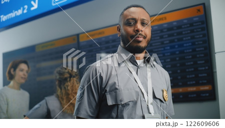 Airport Terminal: TSA Worker in Uniform Looking at Camera 122609606