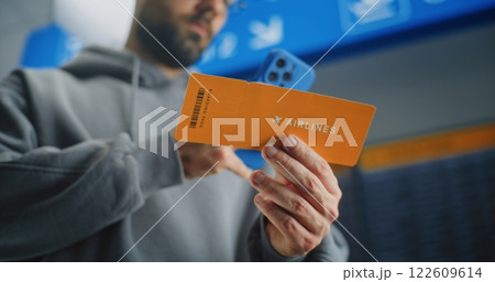 Airport Terminal: Close Up of Male Passenger Scanning Plane Ticket Using Phone Airport Terminal: Close Up of Male Passenger Scanning Plane Ticket Using Phone 122609614