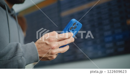 Airport Terminal: Man Using Smartphone to Check Information for Boarding Plane Flight Airport Terminal: Man Using Smartphone to Check Information for Boarding Plane Flight 122609623