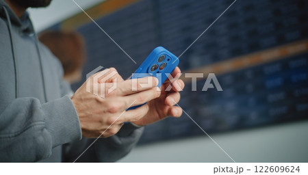 Airport Terminal: Man Using Smartphone to Check Information for Boarding Plane Flight 122609624